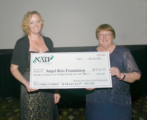 Julie Tholl DeJan, Executive Director of the Angel Kiss Foundation, accepts a check for $14,221.50 from NATP Board Member, Barbara Steponkus.